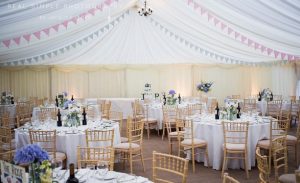 Pastel lined wedding marquee with garland